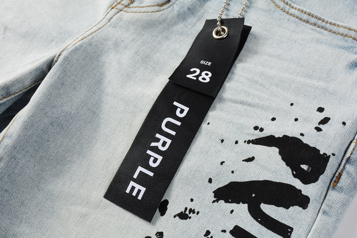 Men Streetwear Denim Shorts Light Blue Wash with Black Paint Streak Print and Raw Hem 5048